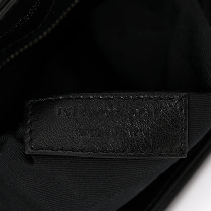 Black leather interior stamp on quilted satchel lining