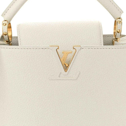 White top-handle bag front with gold LV-style V emblem on flap