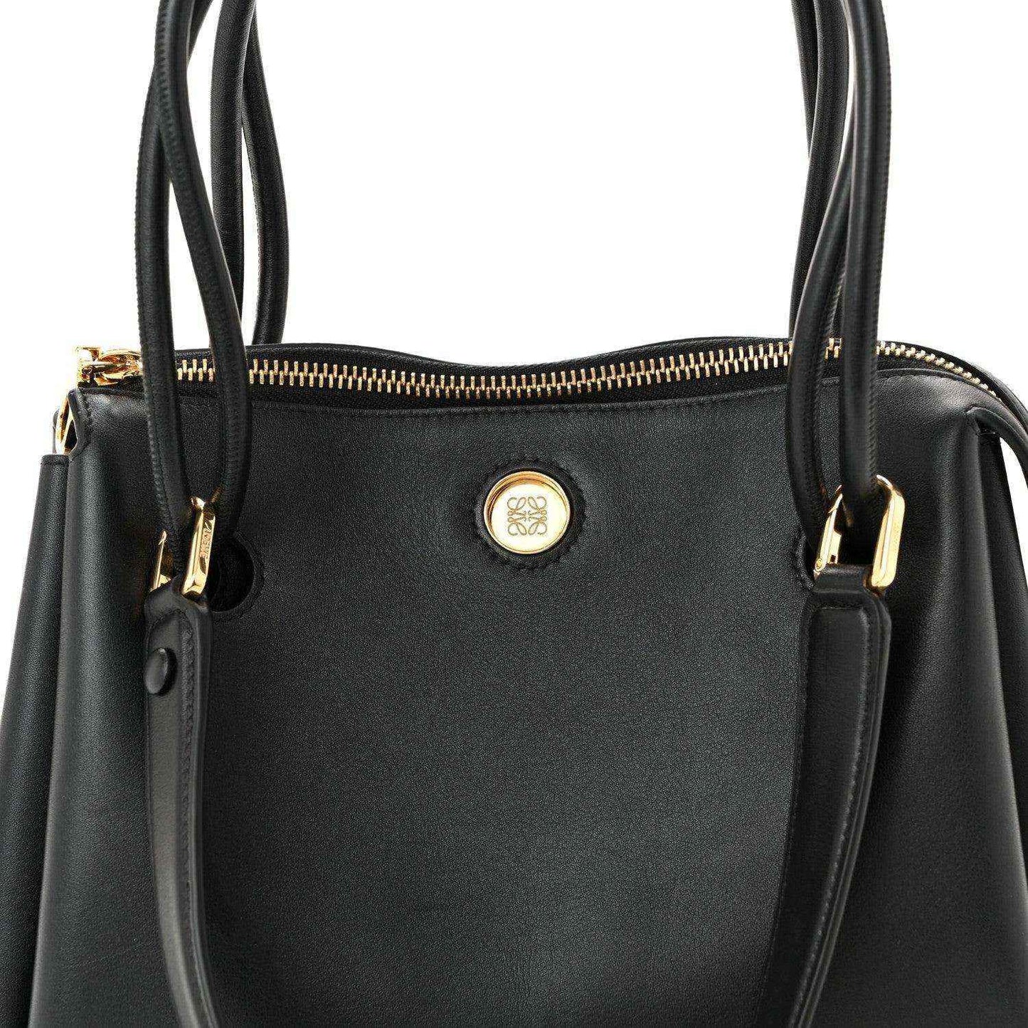 Loewe Small Madrid bag front in black leather with round logo emblem and gold zip.