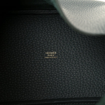 Hermès leather tote bag with pebbled dark green texture and stamp