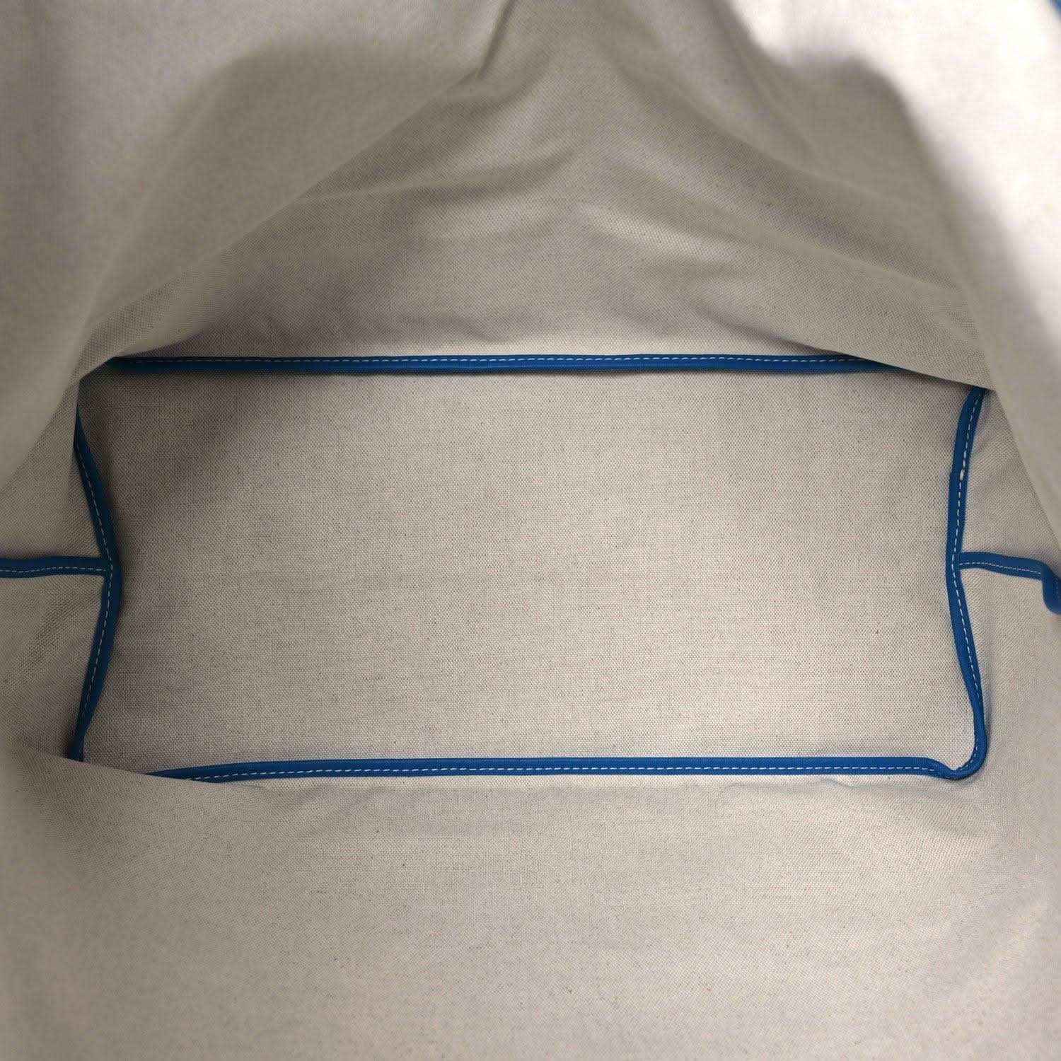 Tote bag interior with light lining and blue trim along the top edge.