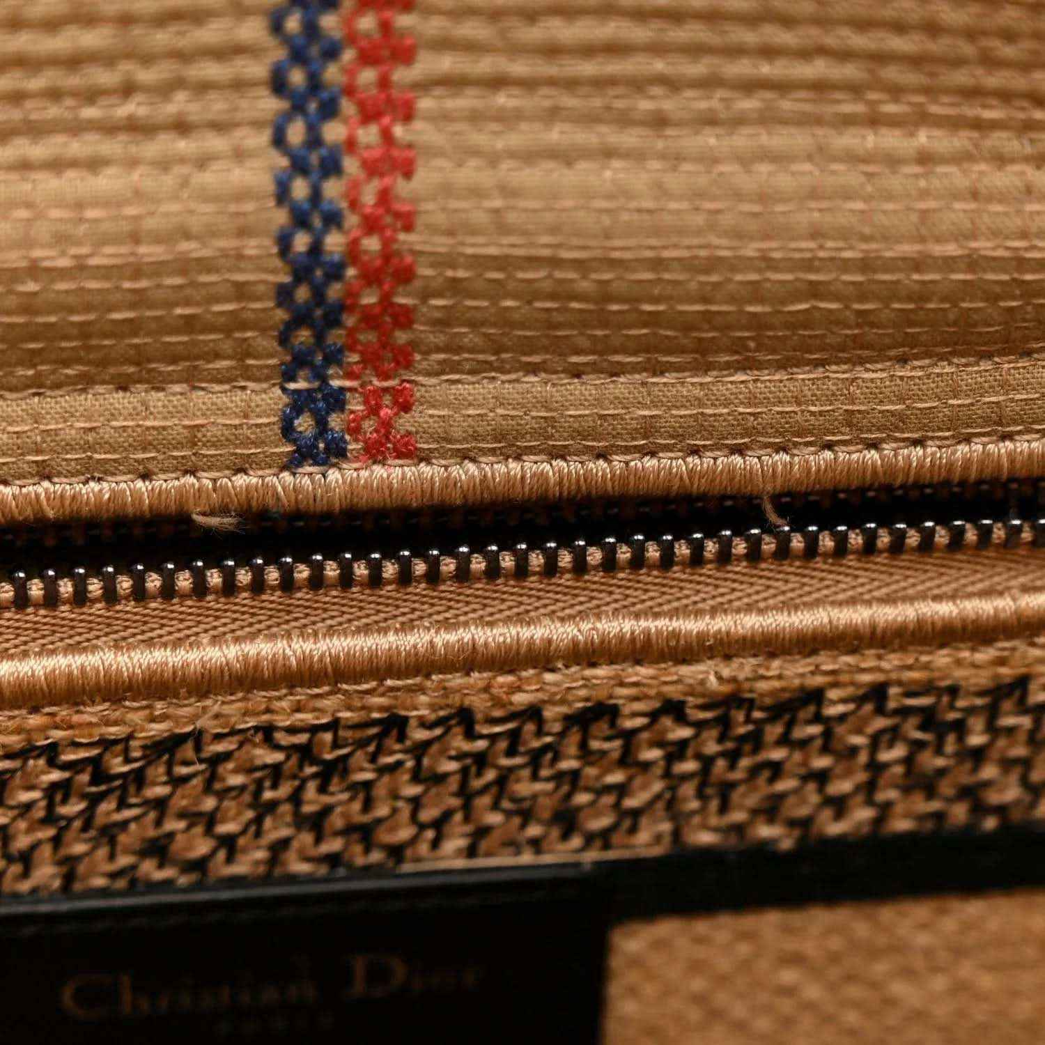 Beige embroidered tote bag with zipper edge and red-blue thread border