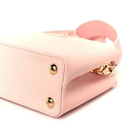 Louis Vuitton Capucines BB shoulder bag close-up with gold snap hardware and handle base