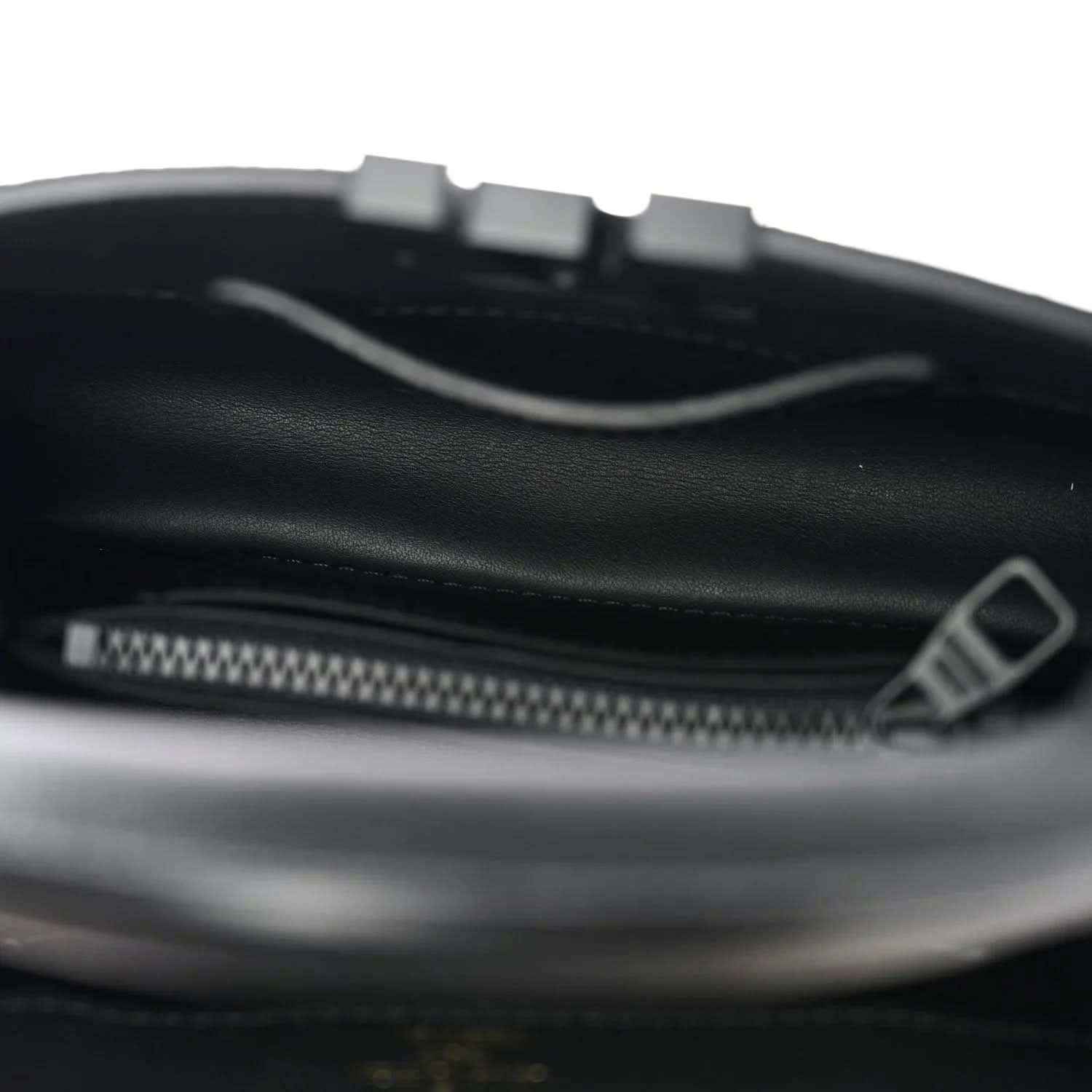 Black leather mini handbag interior with zipper and trim edge