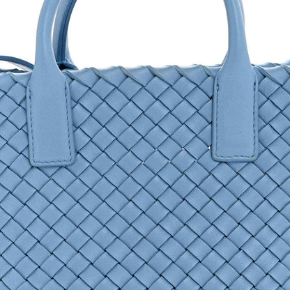 Blue intrecciato mini cabat tote with padded top handles and woven texture close-up