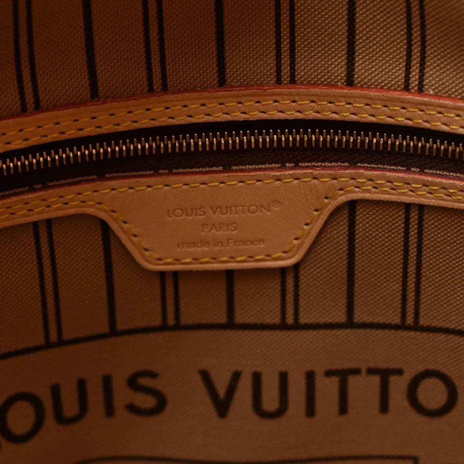 Interior zipper area with Louis Vuitton logo stamp on tan leather patch