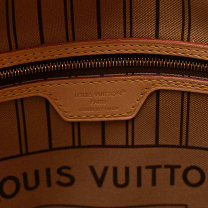 Interior zipper area with Louis Vuitton logo stamp on tan leather patch