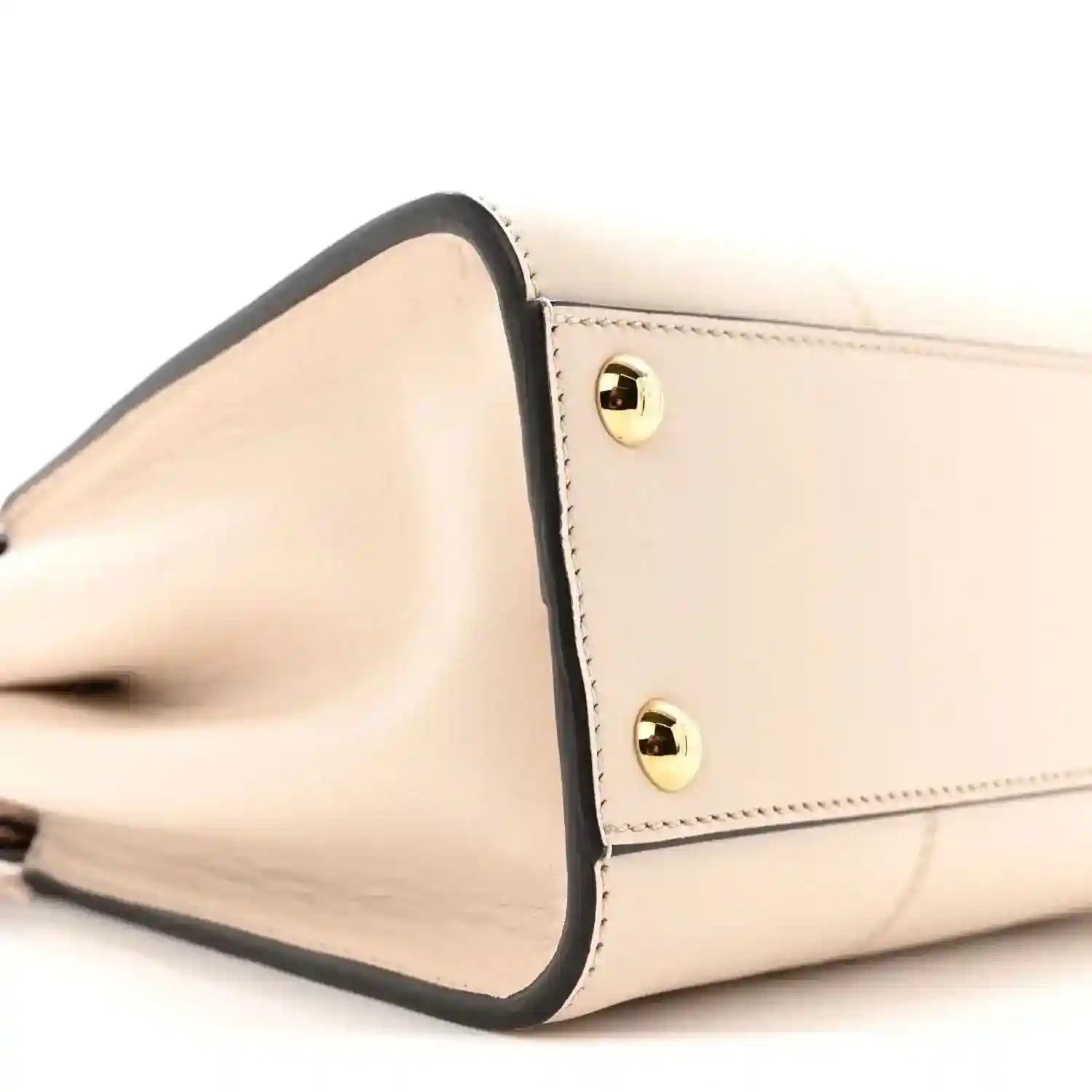 Mini Peekaboo satchel side profile in cream leather with dark trim and gold rivets