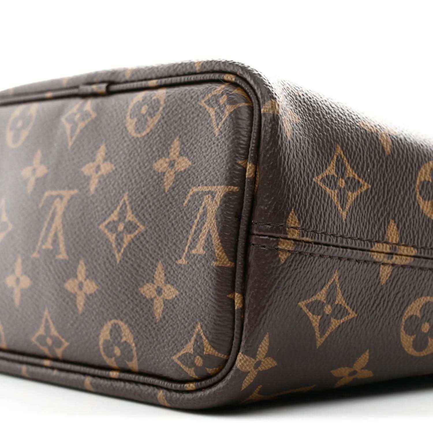 Corner of a dark monogram bag with rounded leather trim and stitched edge seam