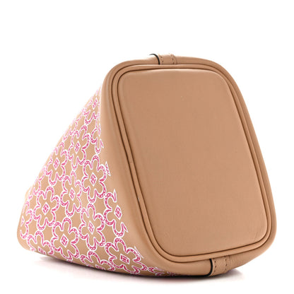 Micro tote bag with magenta floral side panel and tan leather base, rounded top