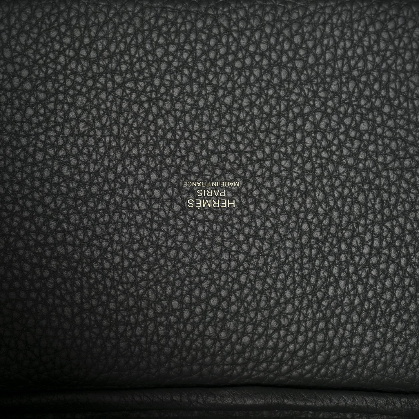 Textured dark green leather lining with small stamped brand lettering.