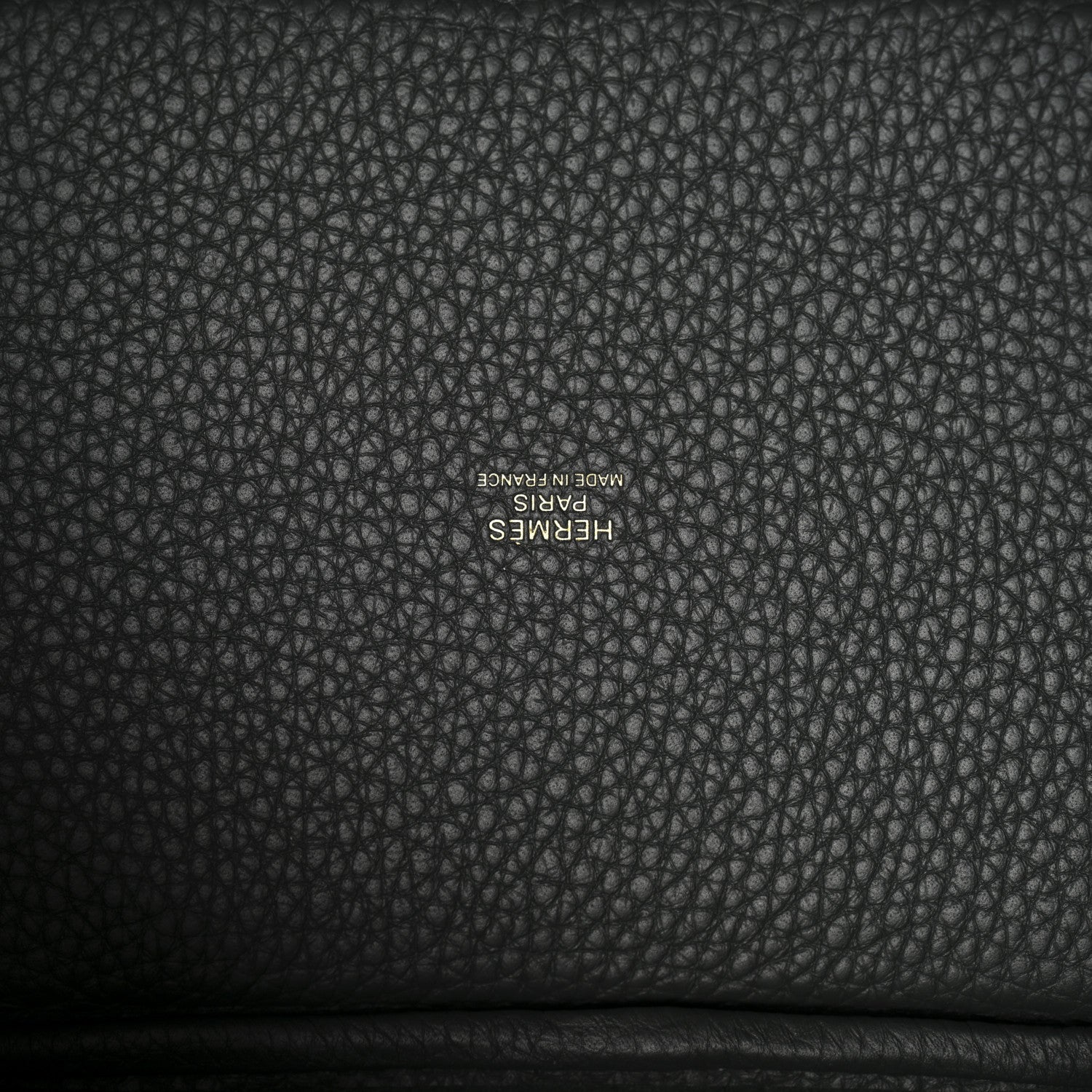 Textured dark green leather lining with small stamped brand lettering.