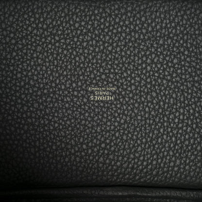 Textured dark green leather lining with small stamped brand lettering.