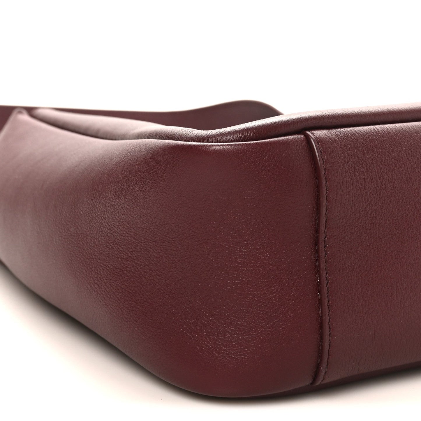 Burgundy leather hobo bag side panel with smooth finish and stitched seam