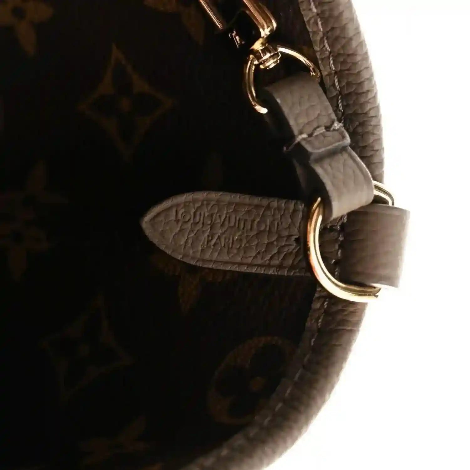 Dark monogram canvas bag with gray leather strap and gold-tone metal ring detail