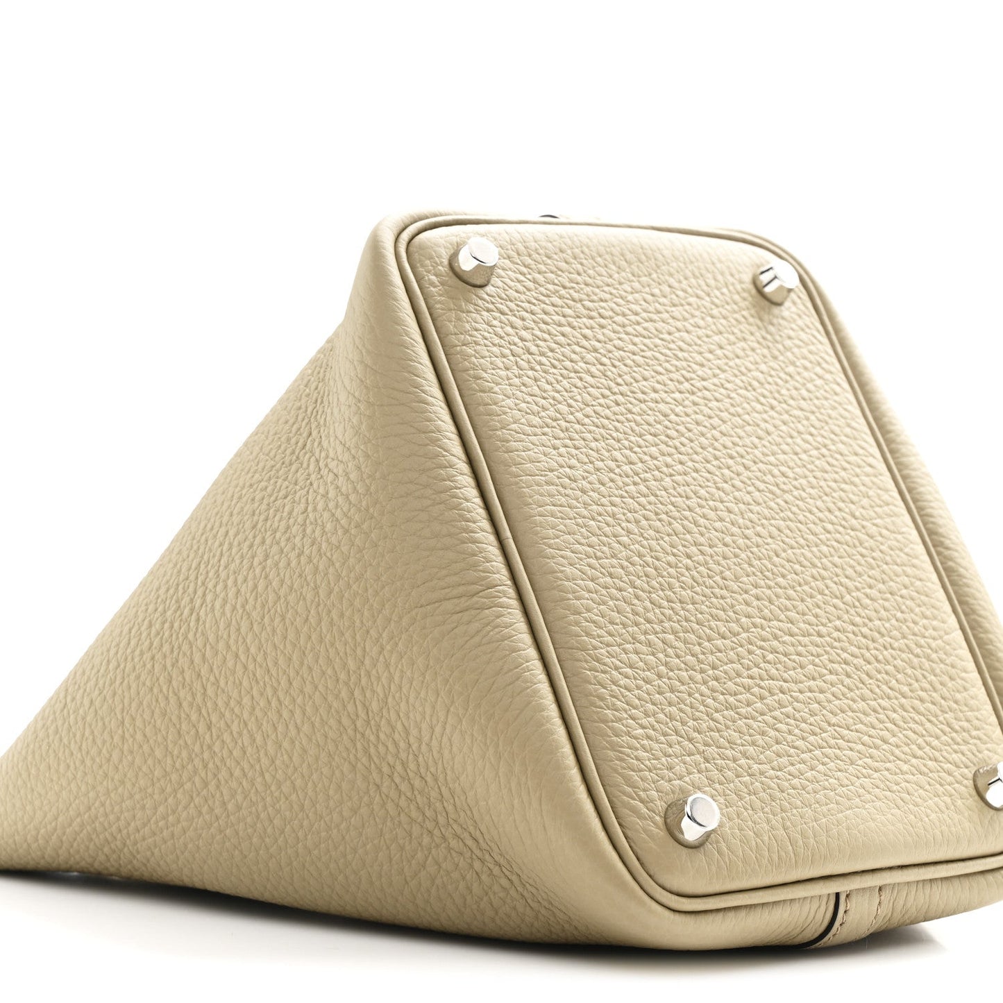 Beige leather handbag with metal corner studs and triangular silhouette