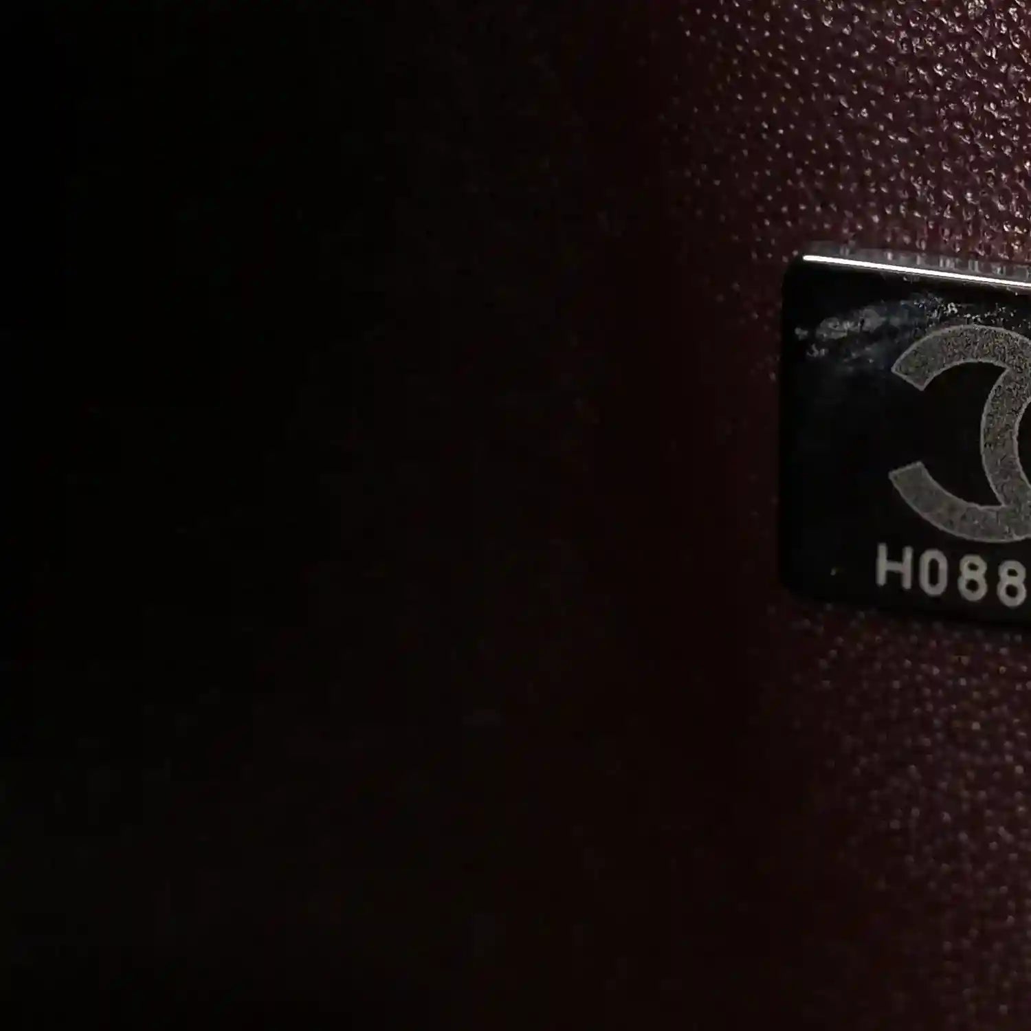 Flap bag interior label holder with printed marking on dark lining