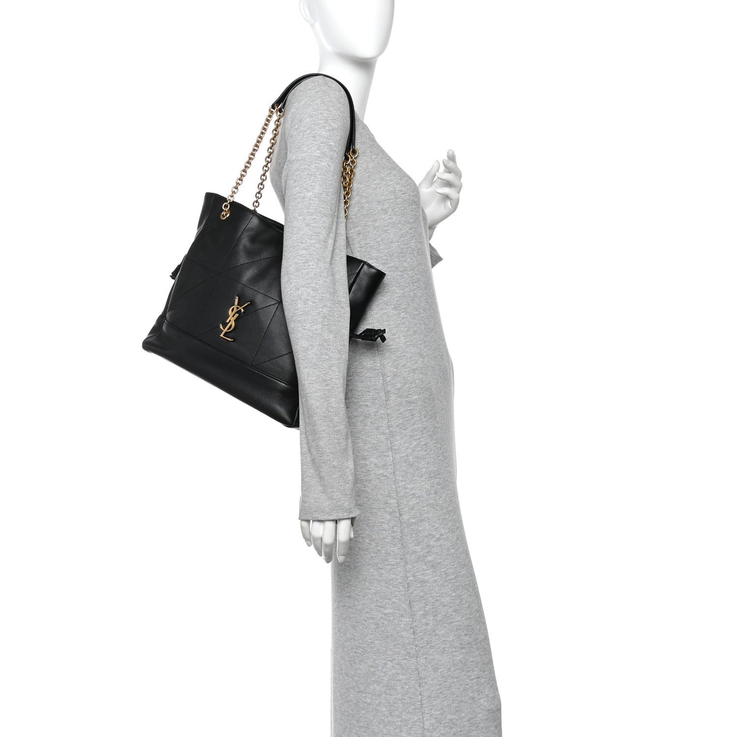 Black small shopping tote on model with gold chain strap and drawstring bow detail.