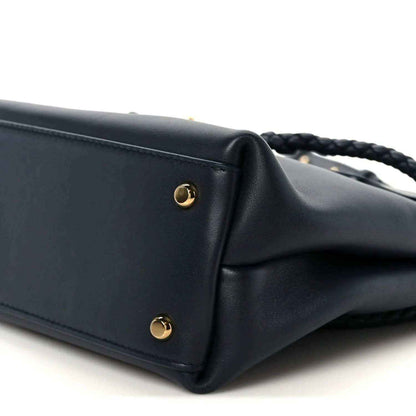 Small black leather handbag corner with gold stud hardware
