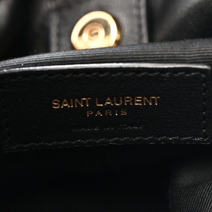 SAINT LAURENT PARIS logo on black leather tab with gold-toned button