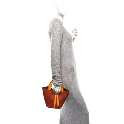 Copper-brown leather mini tote with tan strap detail