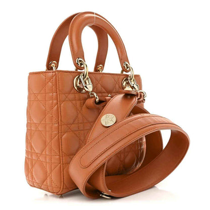 Small Lady Dior tote in orange quilted lambskin with top handles and gold chain drop