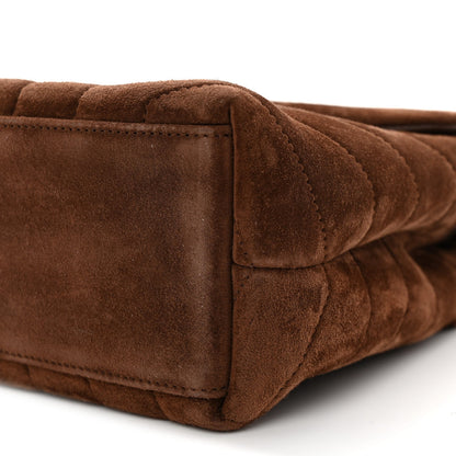 Suede satchel corner with stitching and quilted texture, dark brown