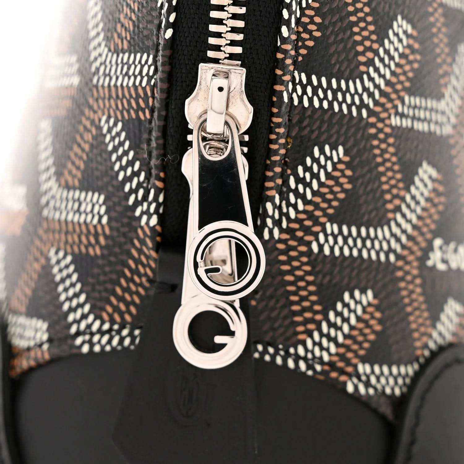 Zip pull hardware with silver D-ring on monogram canvas and black leather trim