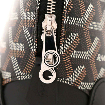 Zip pull hardware with silver D-ring on monogram canvas and black leather trim
