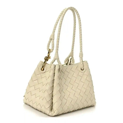 Light cream woven shoulder bag with top handles and gold hardware, front view