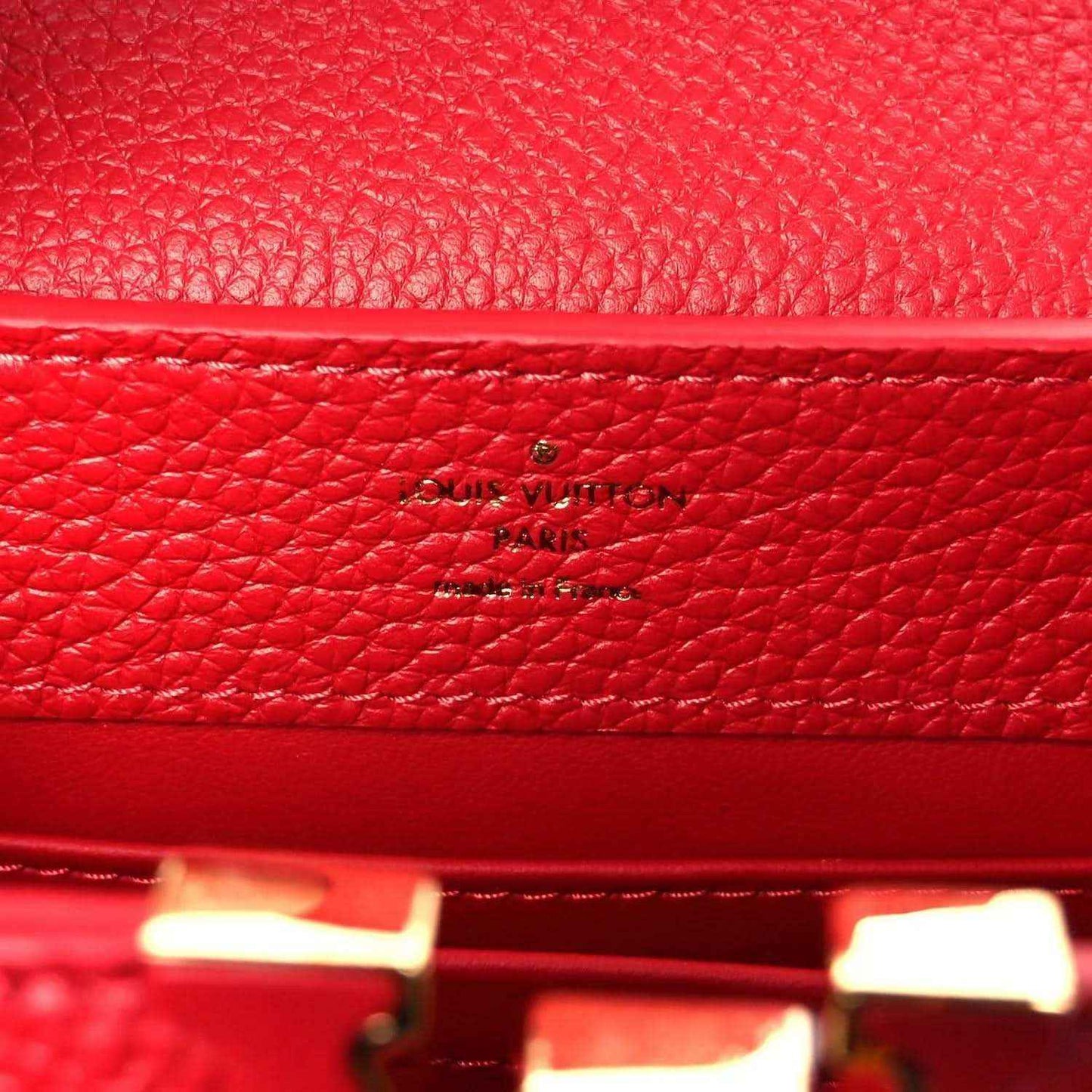 Louis Vuitton scarlet leather mini handbag with embossed logo on inner panel