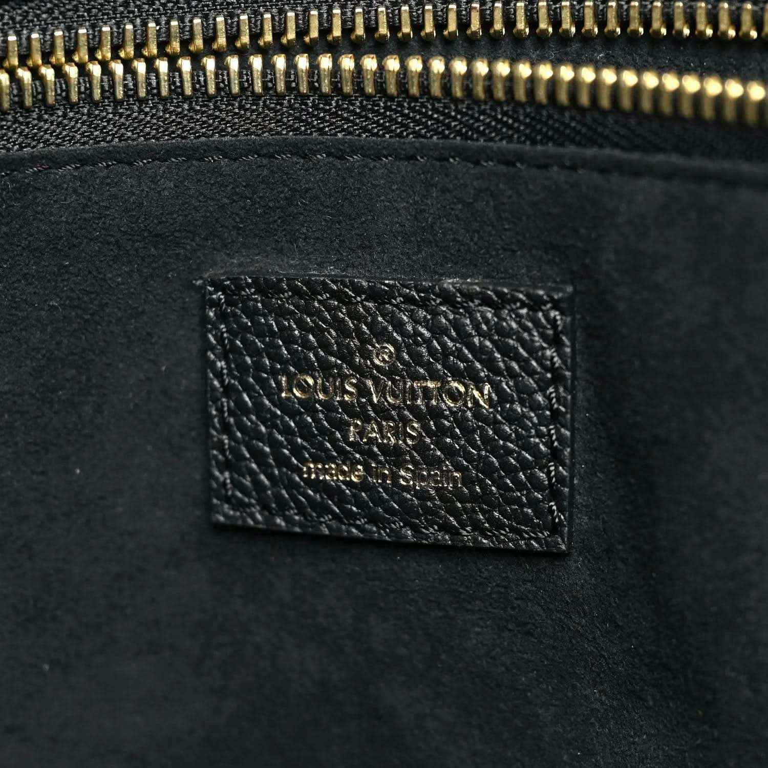 Neverfull MM pouch interior leather patch with gold text near the zipper