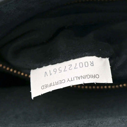 Black leather bag interior with white brand label and model number tag.