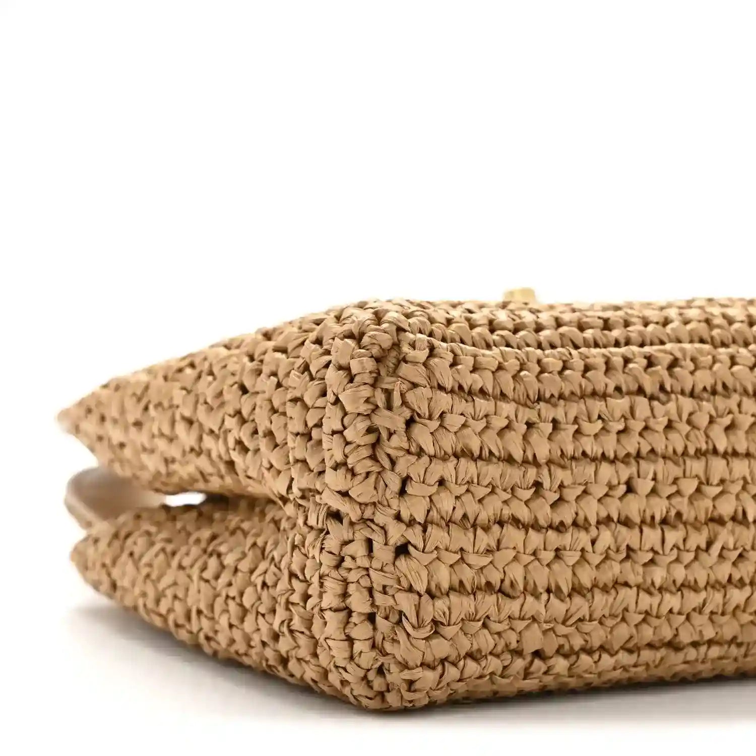 Dark beige braided raffia nano bag side with rolled seam detail