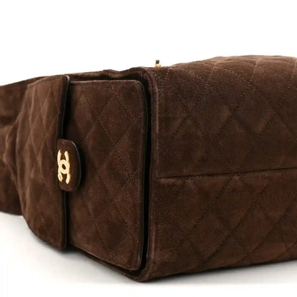 Dark brown suede quilted handbag end pocket with gold logo plaque