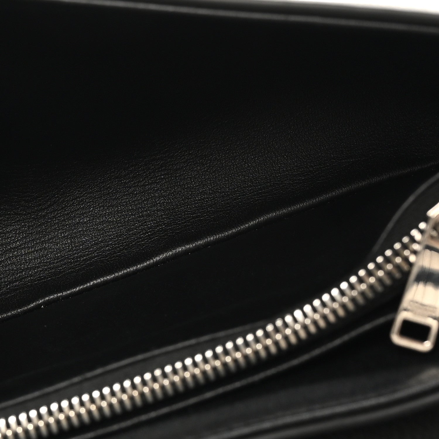 Black leather bag interior with silver zipper and metal zipper pull