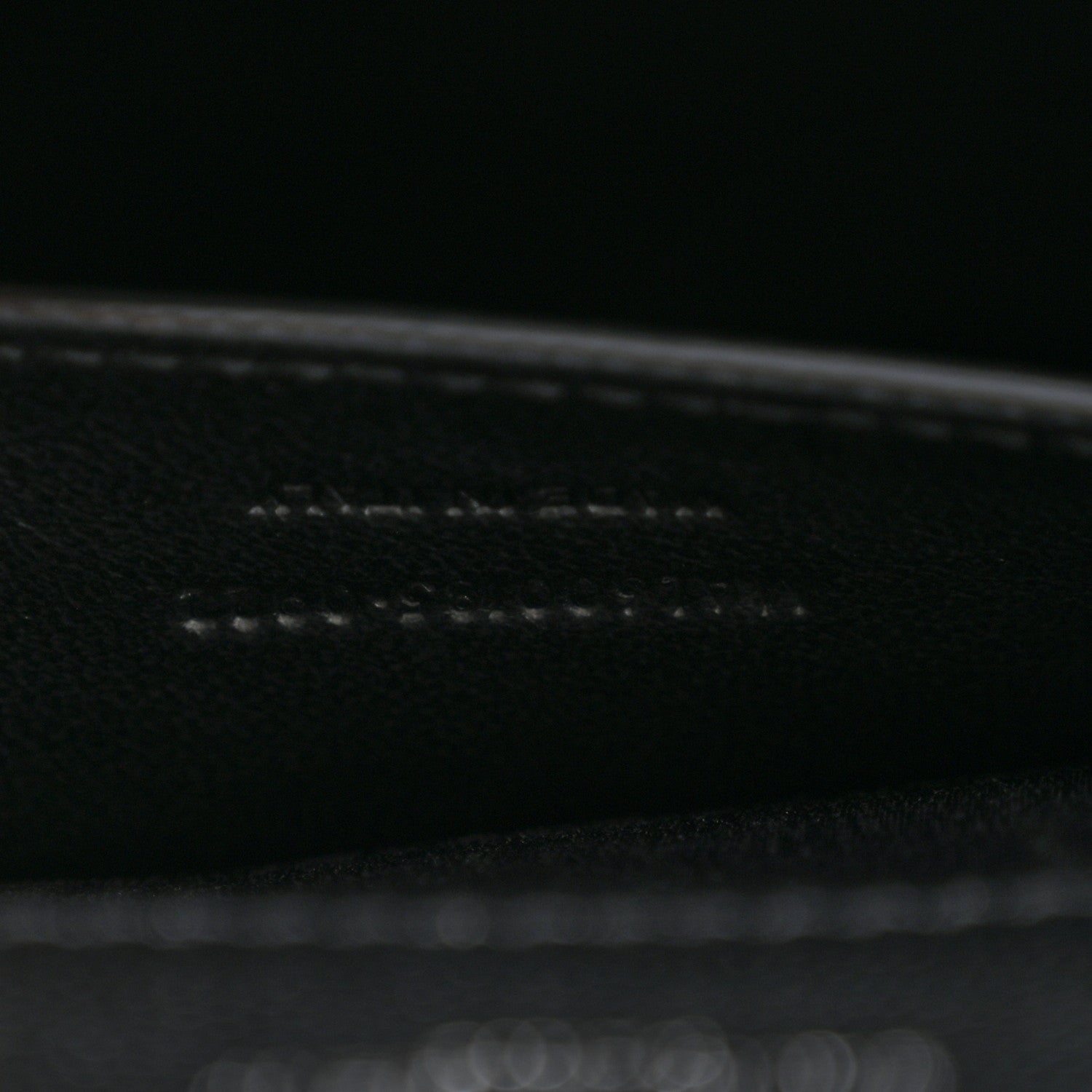 Black leather satchel interior seam and edge stitching close-up