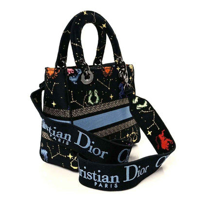 Top-handle handbag with black canvas, zodiac print, and wide CHRISTIAN DIOR band