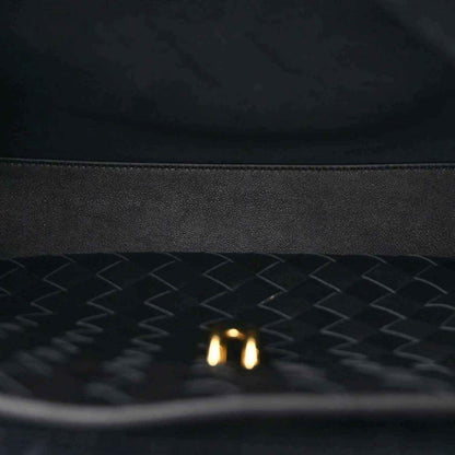 Black leather-lined interior with chevron texture and small gold detail.