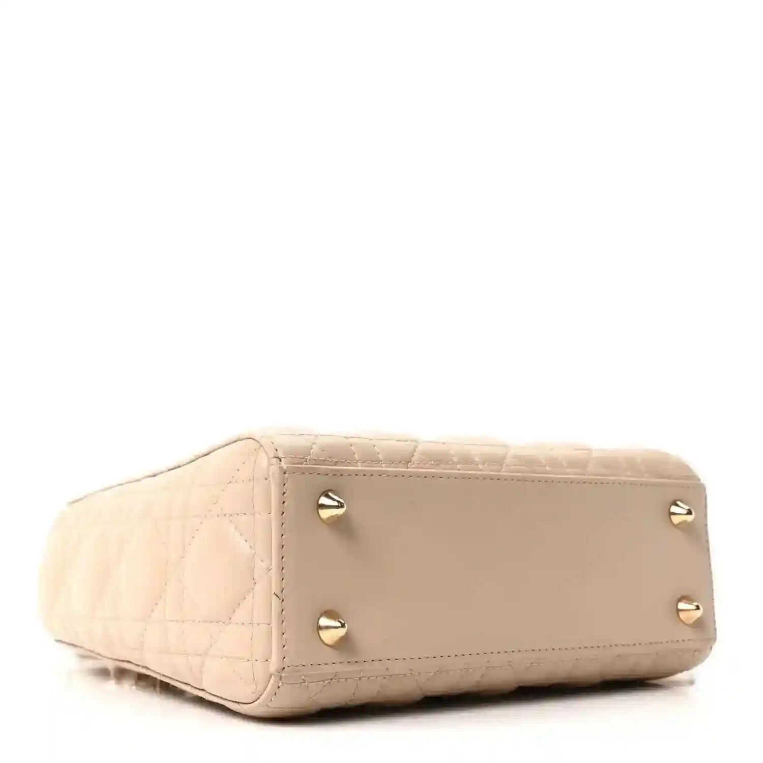 Beige quilted mini handbag with gold corner studs and short top handle