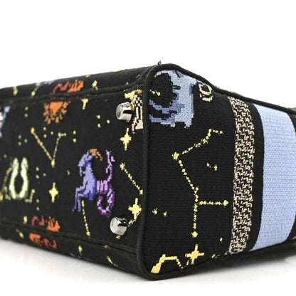 Black embroidered canvas handbag end with zodiac motifs and light blue side stripe