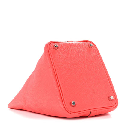 Rose pink leather tote bag with triangular flap and metal corner feet