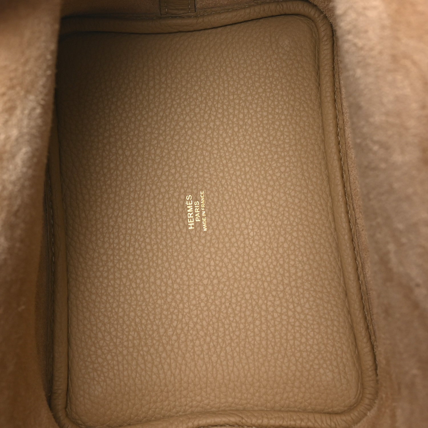 Beige leather interior panel with HERMES logo stamp and stitched edge
