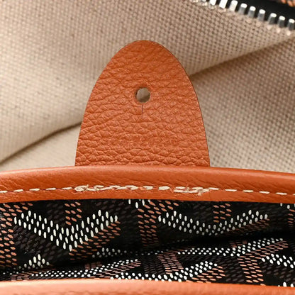 Goyard Artois GM tote bag close-up of tan leather tab and stitching at seam