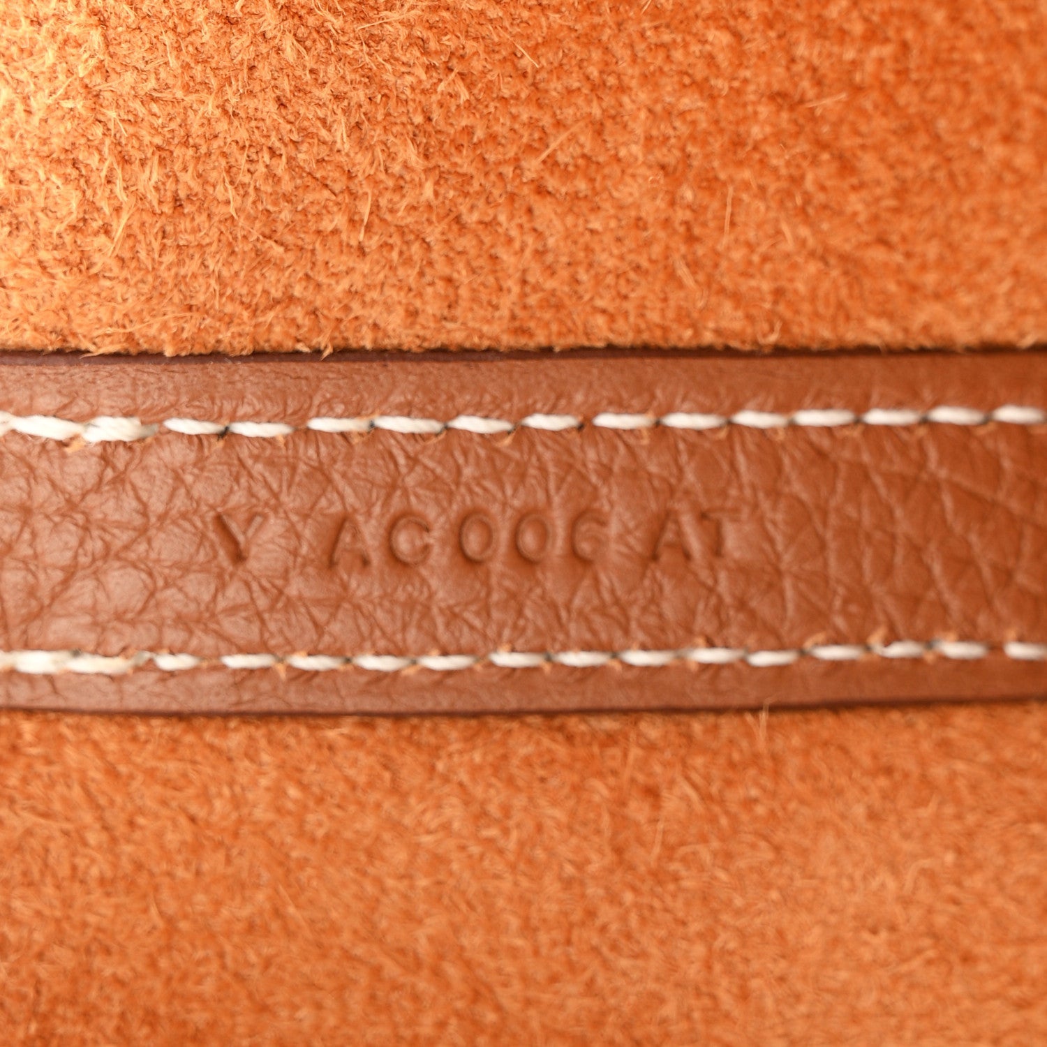Brown leather edge with contrast stitching and sewn seam detail