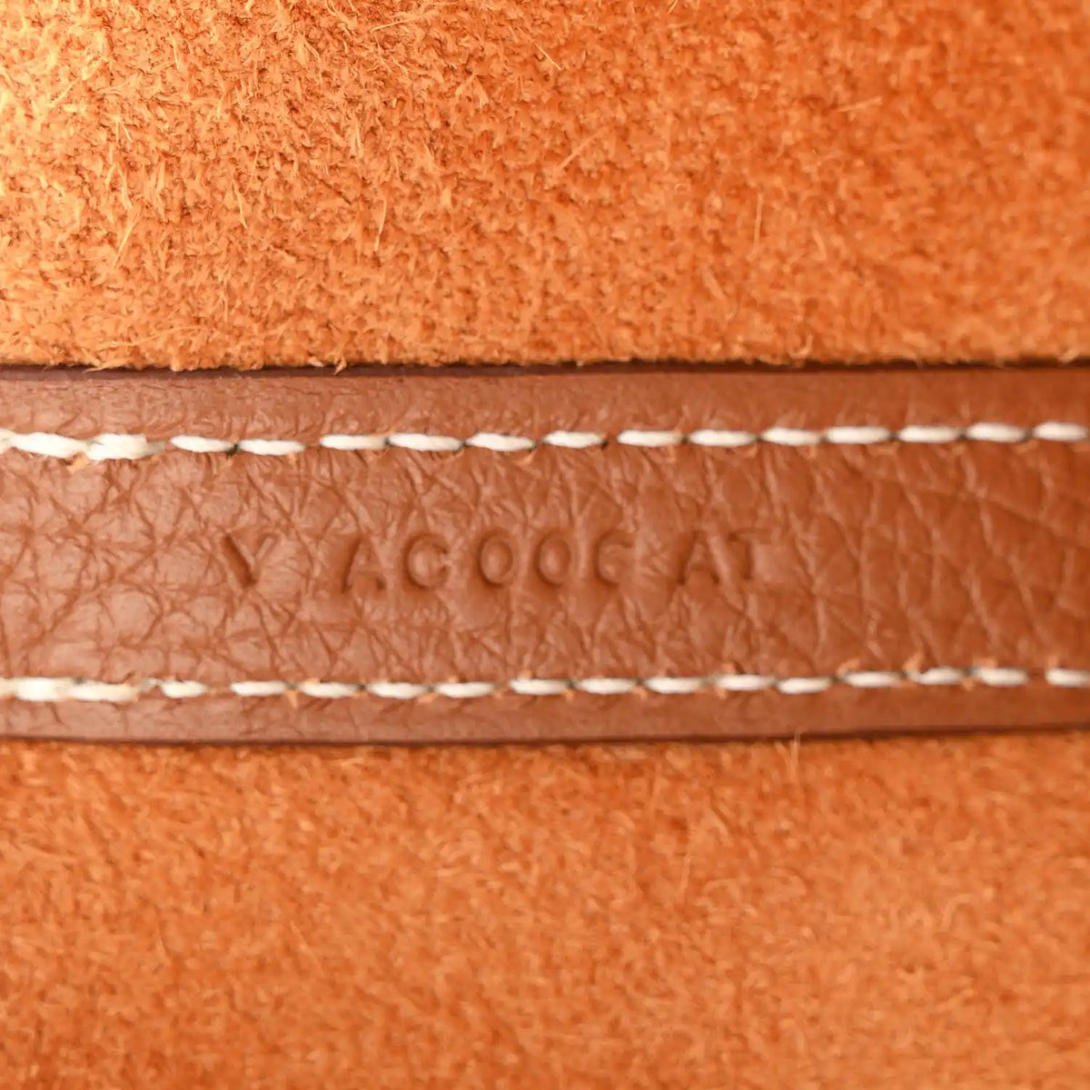 Brown leather edge with contrast stitching and sewn seam detail