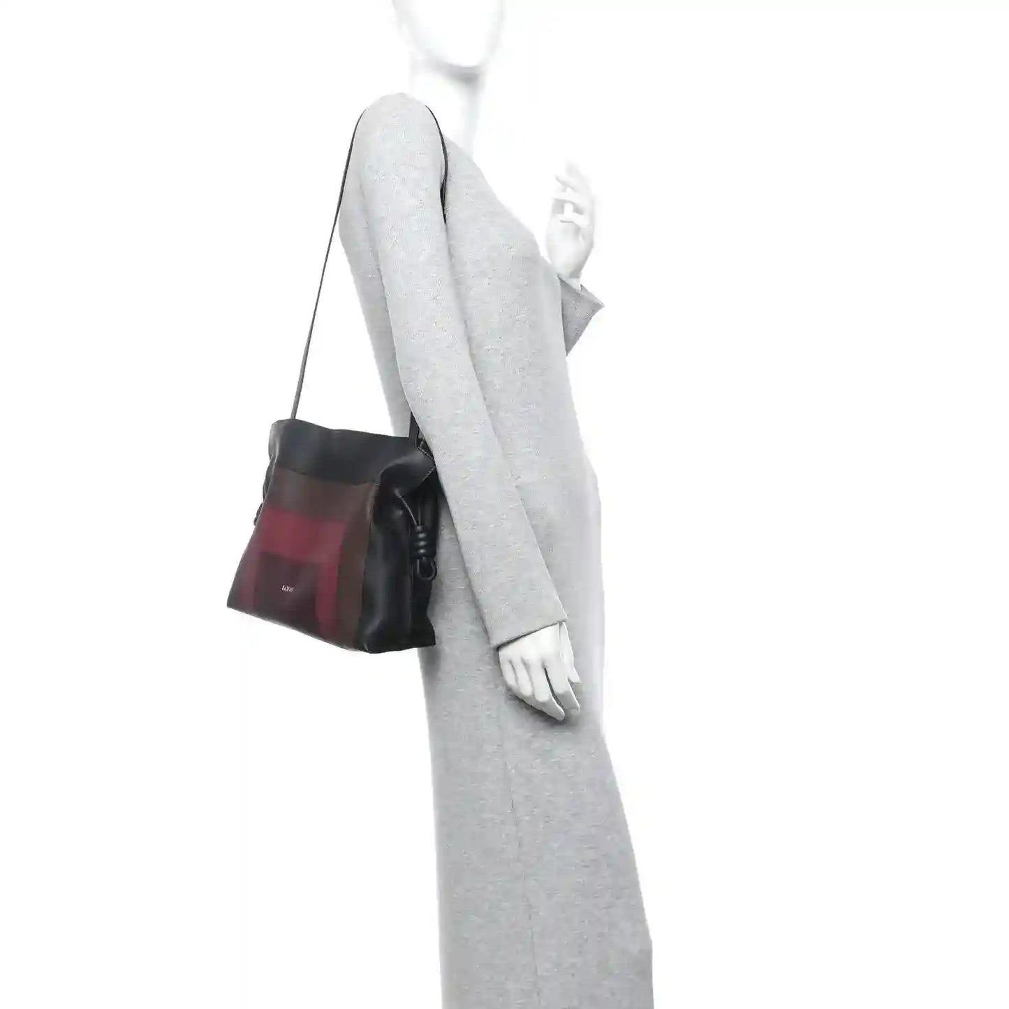 Burgundy-and-black Flamenco knot clutch worn crossbody with black strap
