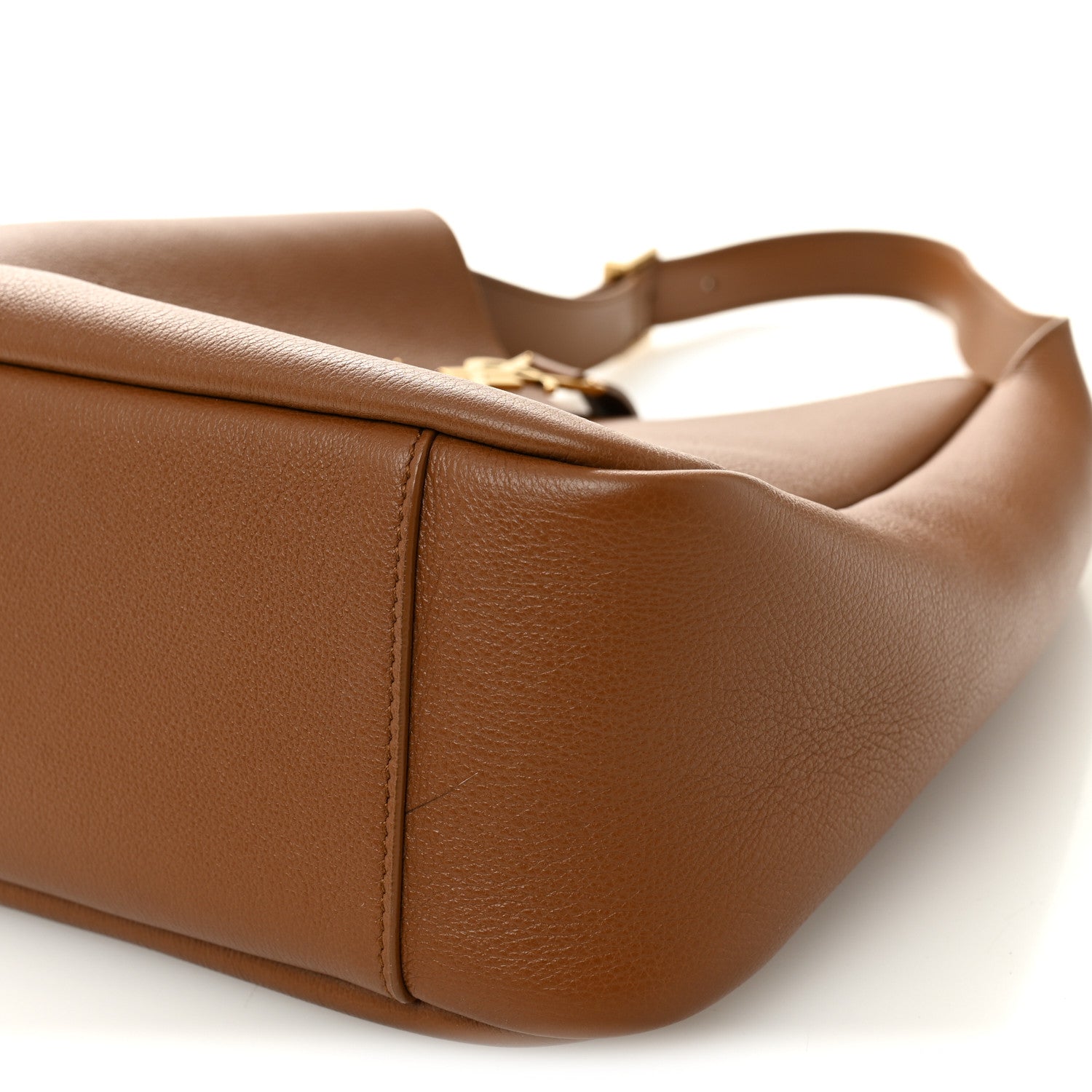 Tan leather hobo bag bottom corner with top handle attachment hardware
