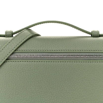 Sage green leather pouch front with top zipper and strap attachment