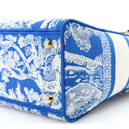 Christian Dior medium tote bag end panel in blue and white toile print with gold snap hardware